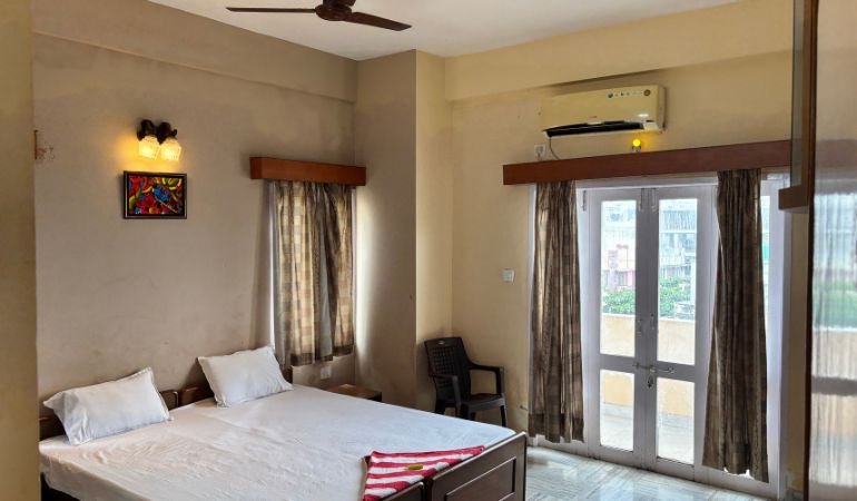 coastal park guest house vizag​ room inside view with clean bed ac and room beach side