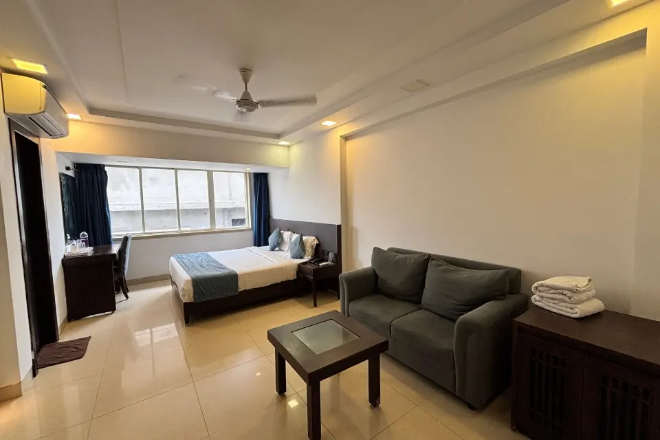 4 star hotels in vizag premium spacious room with ac fan false ceiling sitting area and attached bathroom