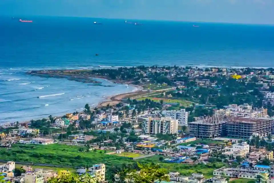best hotels in vizag showing drone view of city and sea with beachside hotel buildings