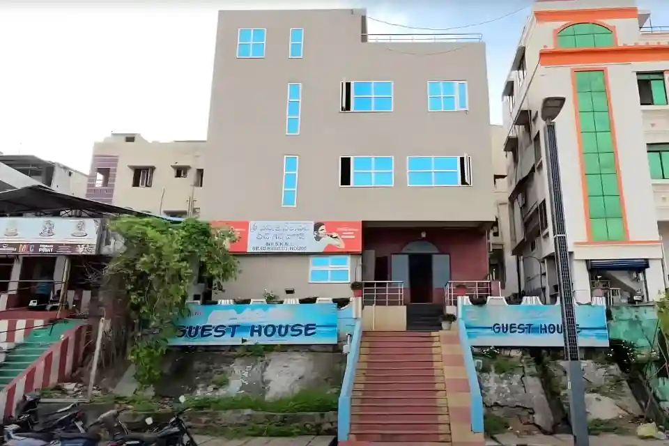 guest house in vizag beach roadside building with sea nearby and clean surroundings
